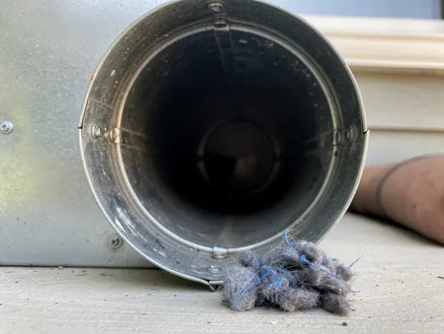 Kent Dryer Vent Cleaning technician using specialized equipment to clear severe dryer vent blockage in Kent
